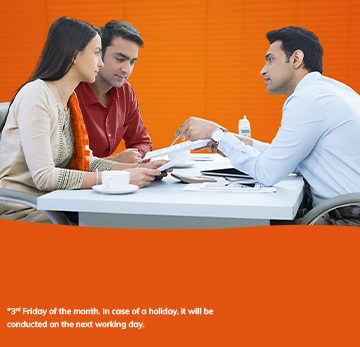 MILAP Grievance Redressal Day: share feedback every 3rd Friday. Bank representative meeting with a couple.